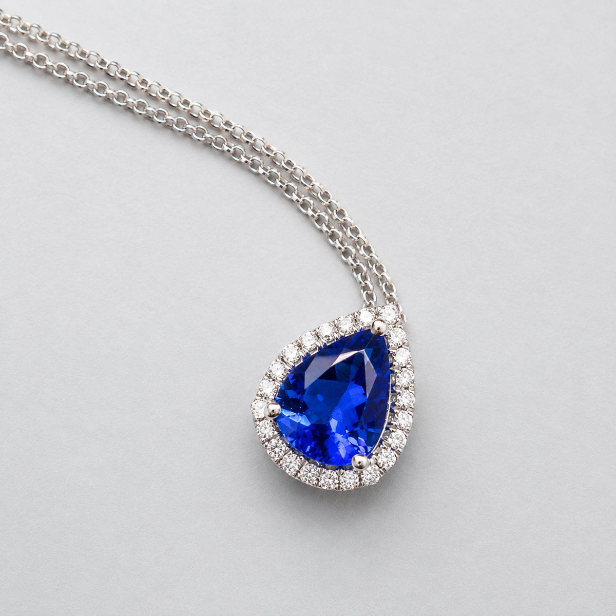 Pear-Shaped Tanzanite Pendant With Diamond Halo in a small size AAA grade tanzanite