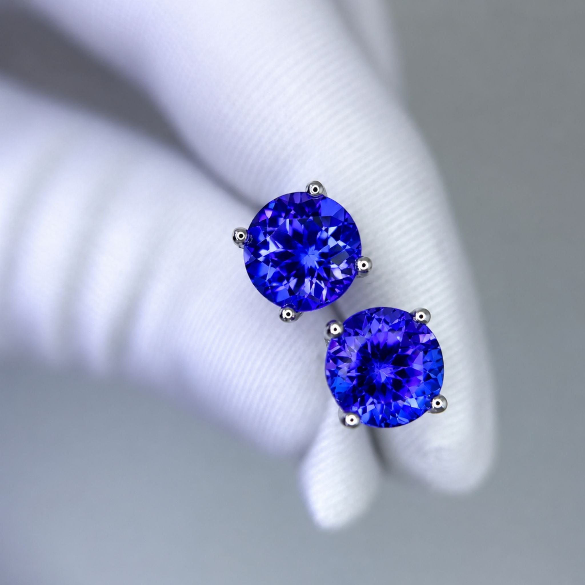 Heirloom quality round tanzanite earrings crafted in white gold