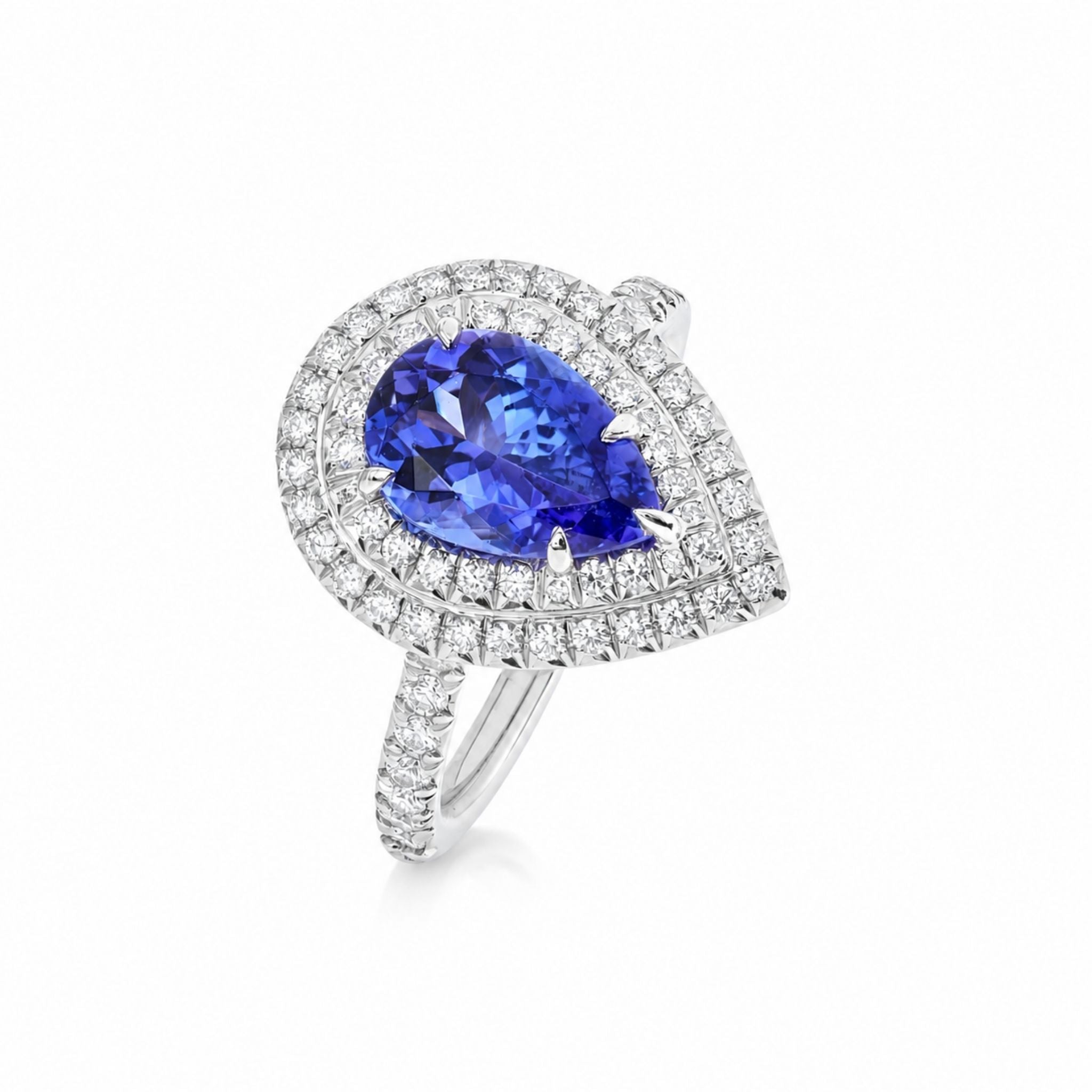A pear-shaped ring featuring a vibrant blue tanzaite gemstone surrounded by a double halo of diamonds