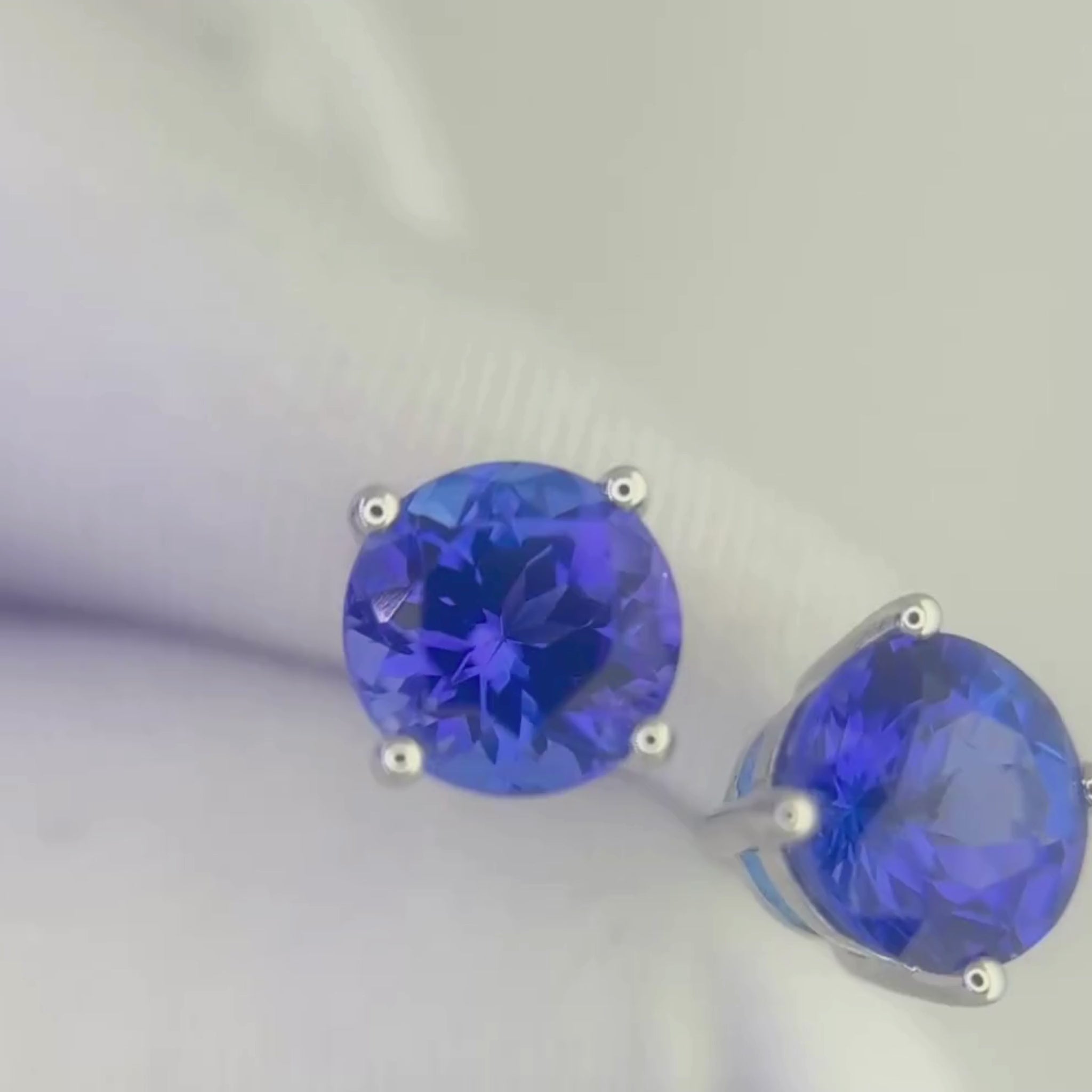 round  cut tanzanite earrings with rich blue and violet hues