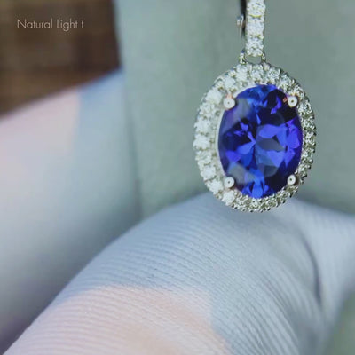Oval tanzanite earrings with diamonds featuring vivid blue-violet natural tanzanites and brilliant diamond accents.