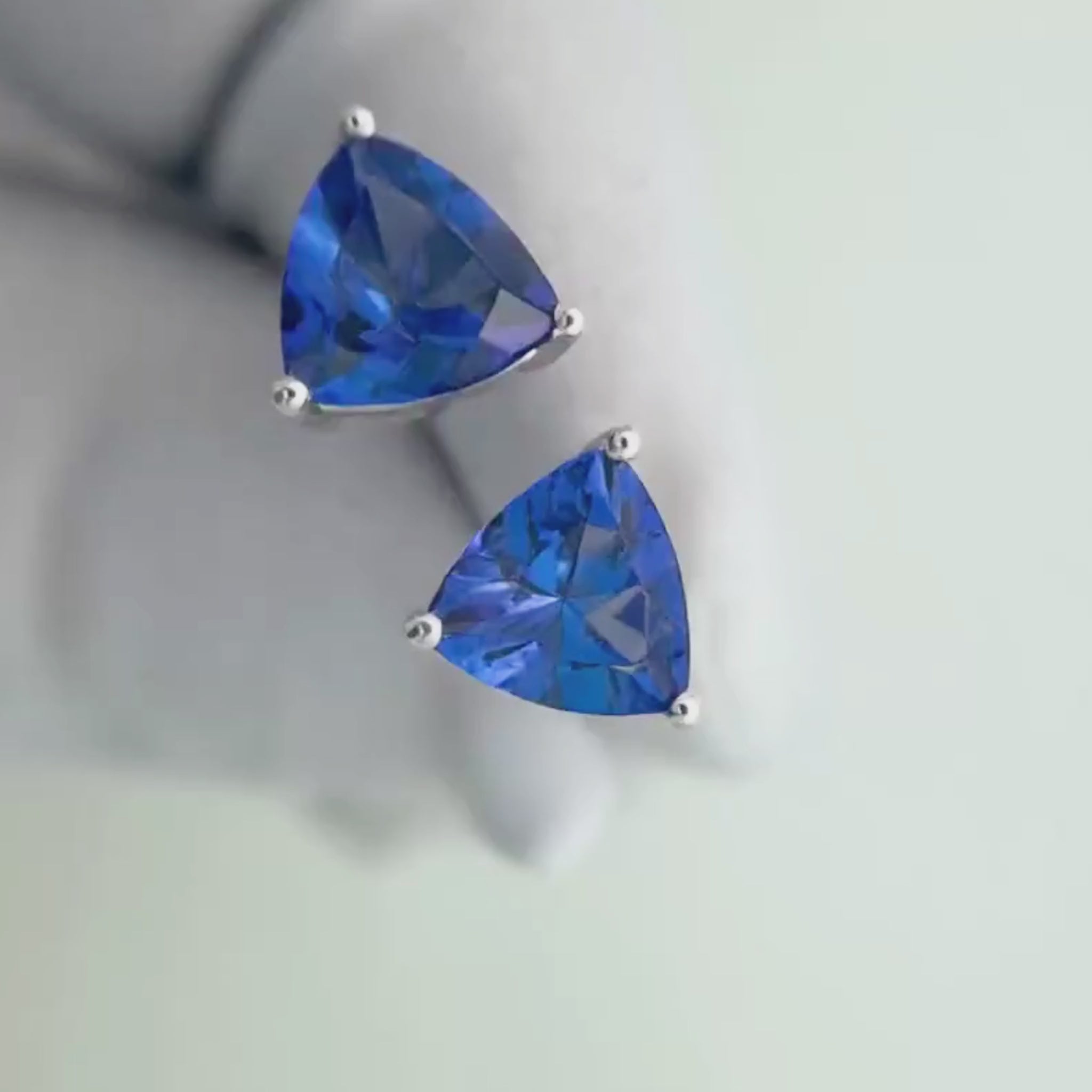 Trillion cut tanzanite earrings featuring vivid blue-violet natural tanzanites
